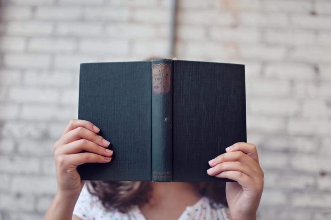 female student reading a book