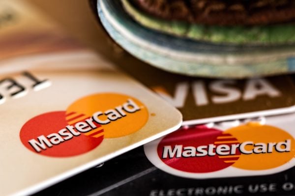 A stack of credit cards fanned out across a table.