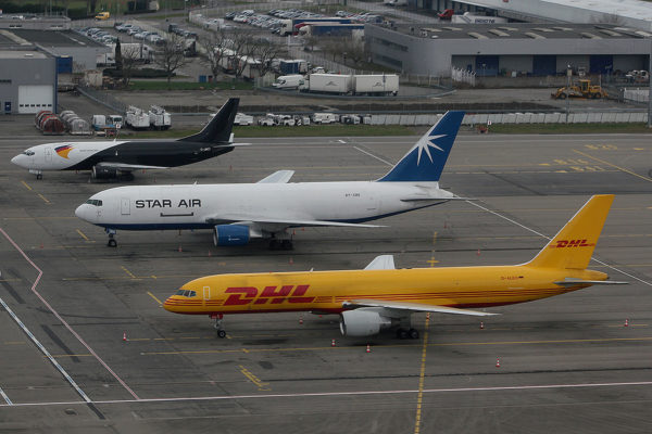 Three cargo planes on the runway.