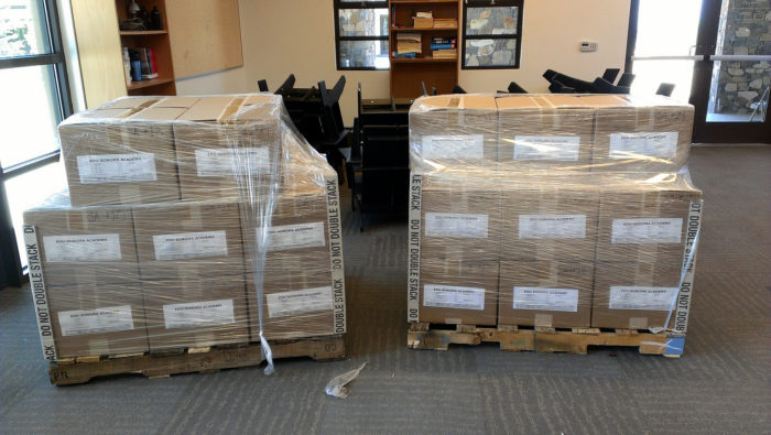 Two pallets full of boxes wrapped in plastic wrap.