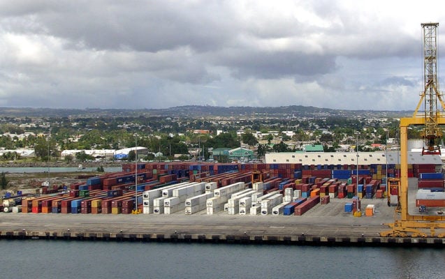 A bird's eye view of a shipping port and shipping containers.