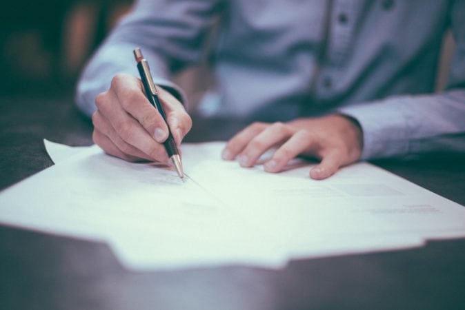 A man filling out paperwork.