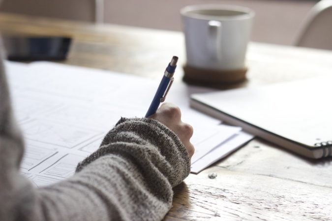 A woman writing on an application.