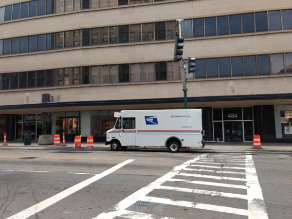 USPS truck parked alongside the street.