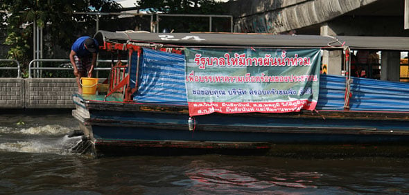 Thai Floods: Six Boats Pushing Flood Water
