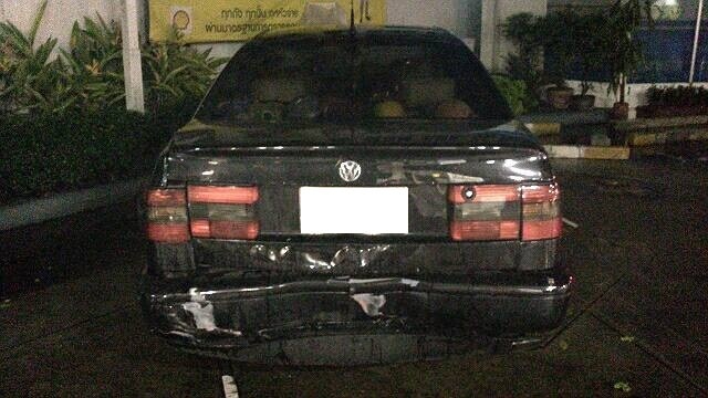 A damaged rear bumber on a black car.