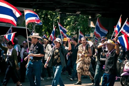 A group of protesters marching down the road.