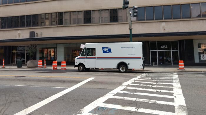 USPS truck parked alongside the street.