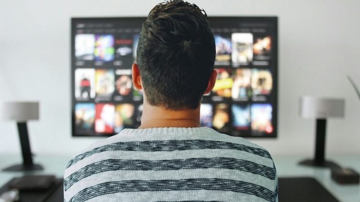 a man watching TV to learn French