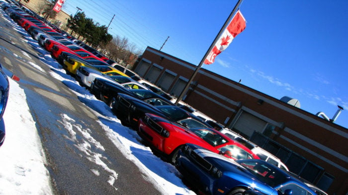 A line of cars for sale at a car dealership.