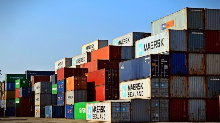 A stack of shipping containers in a shipping yard.