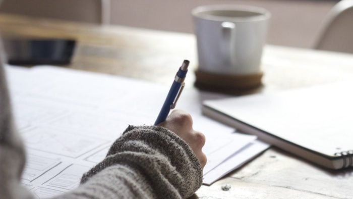 A woman writing on an application.