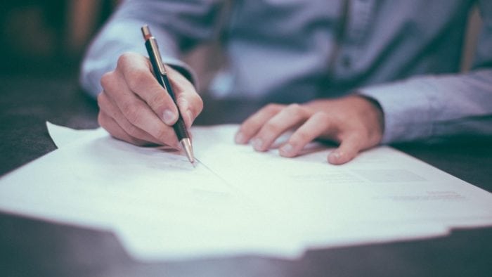 A man filling out paperwork.