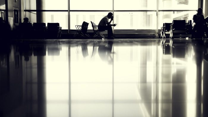 A man waiting in a hospital lobby.