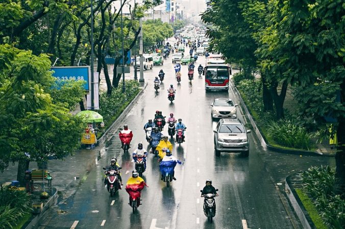 Riding a bike in Saigon during rainy season. 