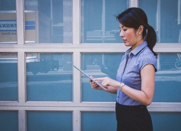 an Asean woman on a tablet. 