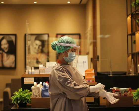 Women in a clinic with gloves and face shield