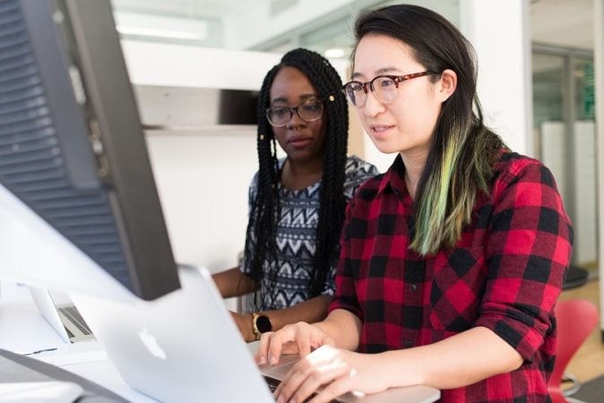 A pair of women of different ethnicities working together in China 