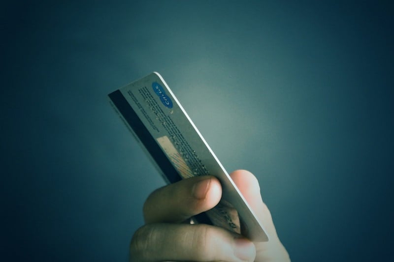 a close up of a hand holding a credit card