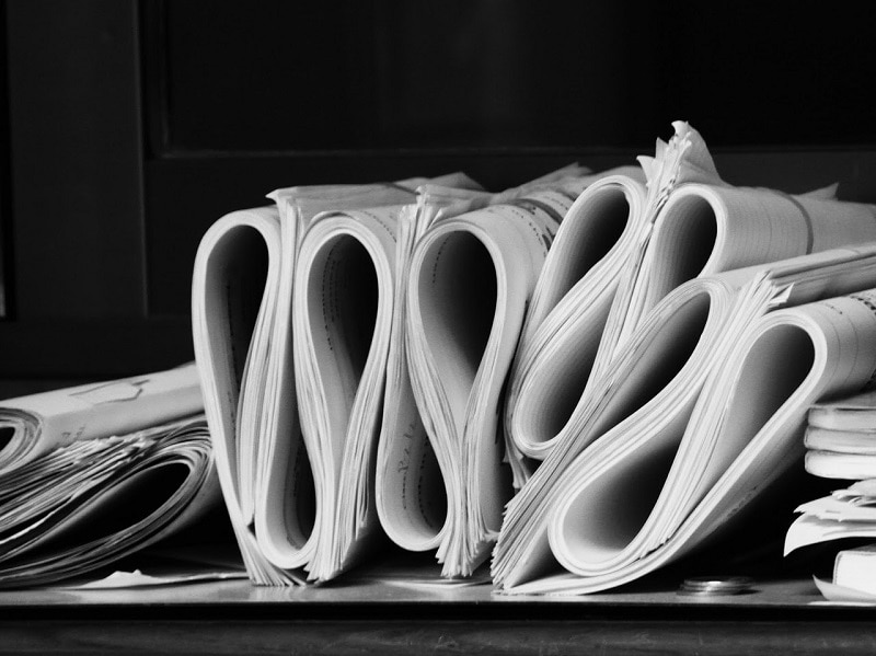 piles of accounting paperwork on a table 