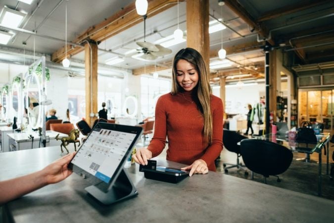 Woman paying at a beauty salon with a credit card