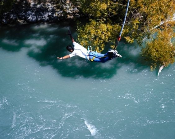 Man bungee jumping in China over river