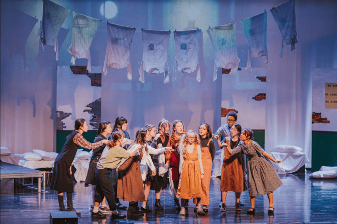 A theatre performance on stage by American International School students.