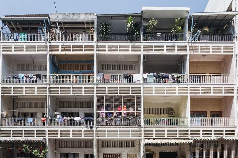 A photo of balconies of from the outside of an older condo building in Cambodia.