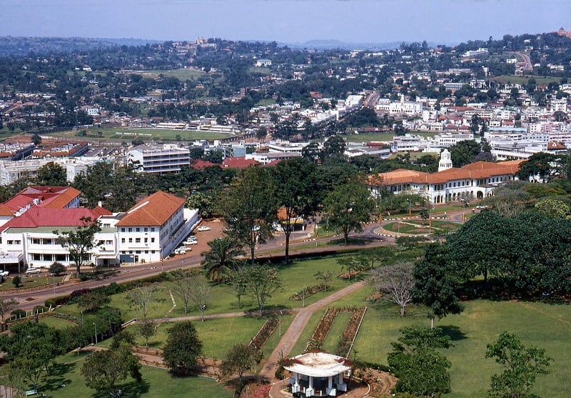 A view over hilly and green Kampala city, Uganda with whit colonial style building sin the foreground. 