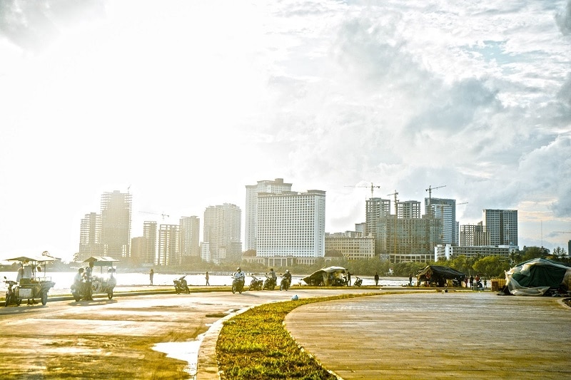 View of waterside condo buildings from a park in Cambodia. 