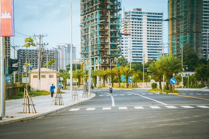 Cambodia street with construction of modern apartment buildings going up. 