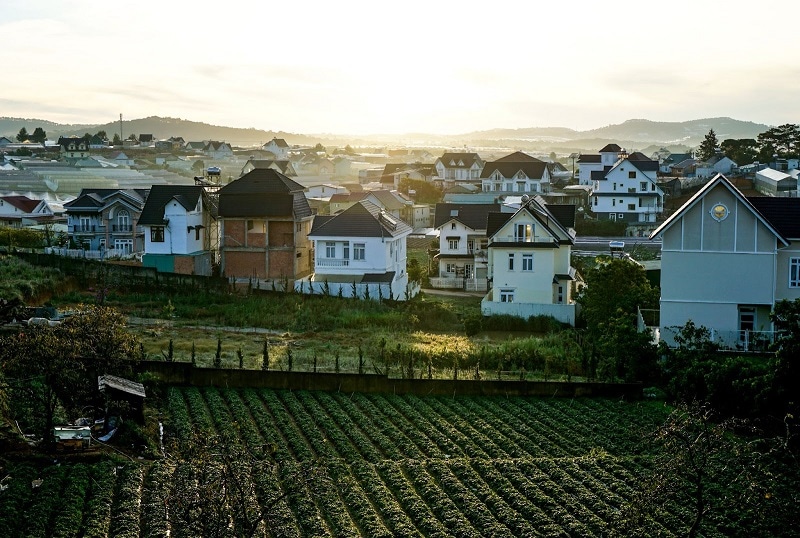 A bucolic view of large houses and green hills in Da Lat, Vietnam. 