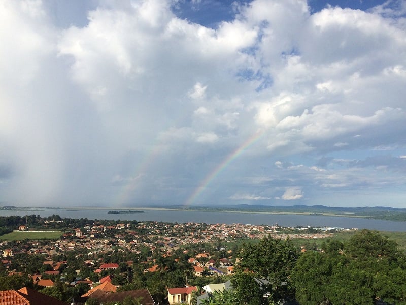 A view of rainbows over green Kampala Uganda with the river in the background. 