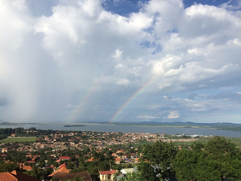 A view of rainbows over green Kampala Uganda with the river in the background.