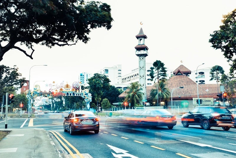 a low-shutter-speed photos of cars on a calm Singapore road 
