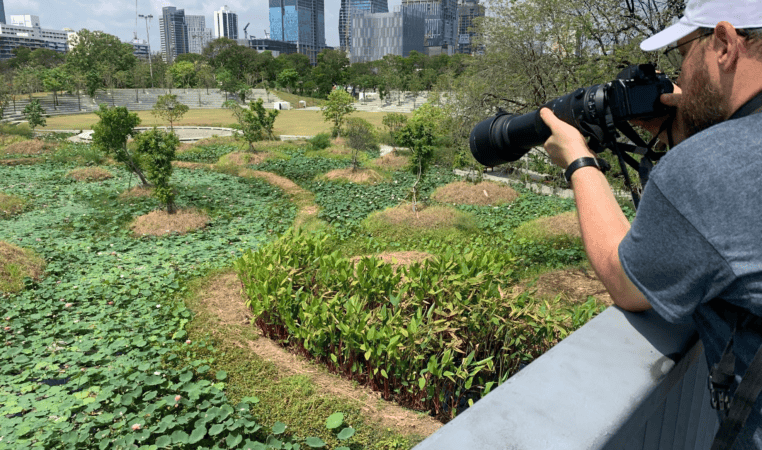 A Bird nerd in Benchakitti Forest Park. with the longest lens to photograph birds. 