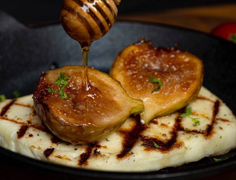 Grilled Saganaki cheese with caramelized figs and greek honey at Avra in Bangkok. 