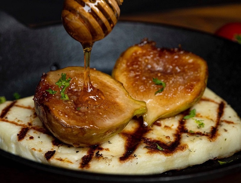 Grilled Saganaki cheese with caramelized figs and greek honey at Avra in Bangkok.
