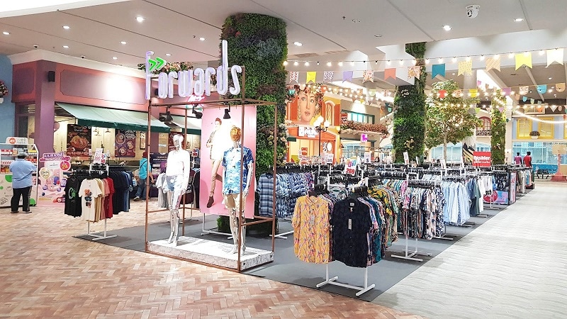 a Forwards op-up market in the basement of a mall in Bangkok with clothing on display 