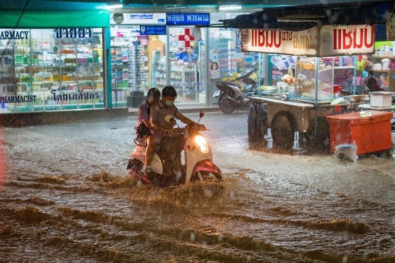 ride a bike in Thailand flood. 