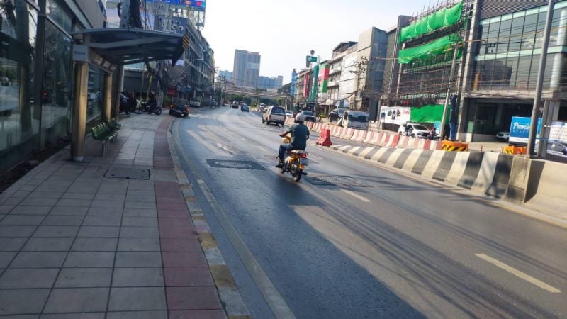 riding a motorcycle in the middle of the road in Thailand. 