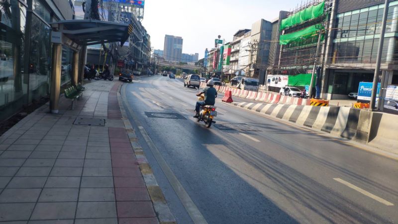 riding a motorcycle in the middle of the road in Thailand.