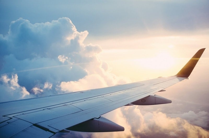 Cruising above the clouds on a commercial aircraft.
