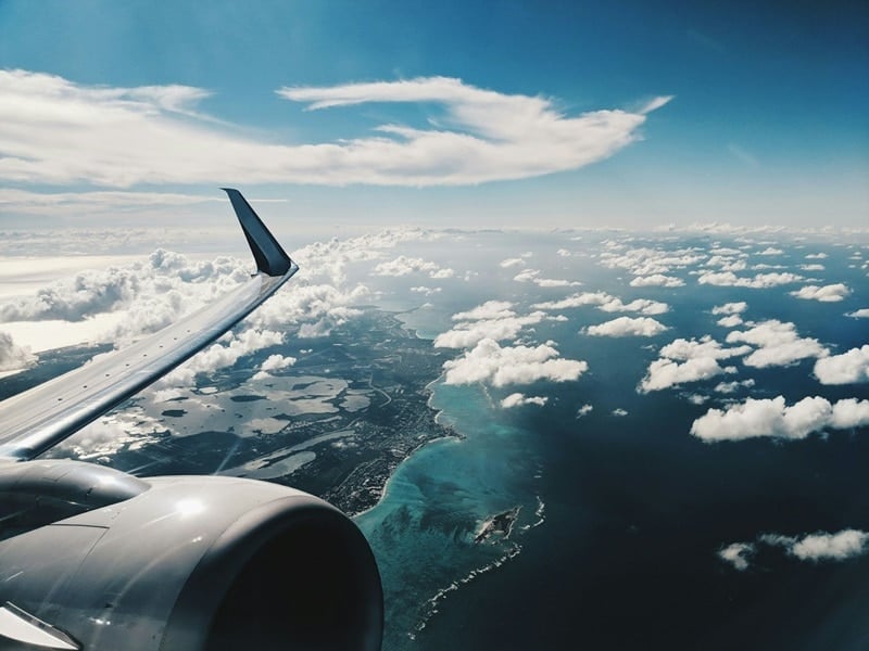 an airplane flying over a cruise ship