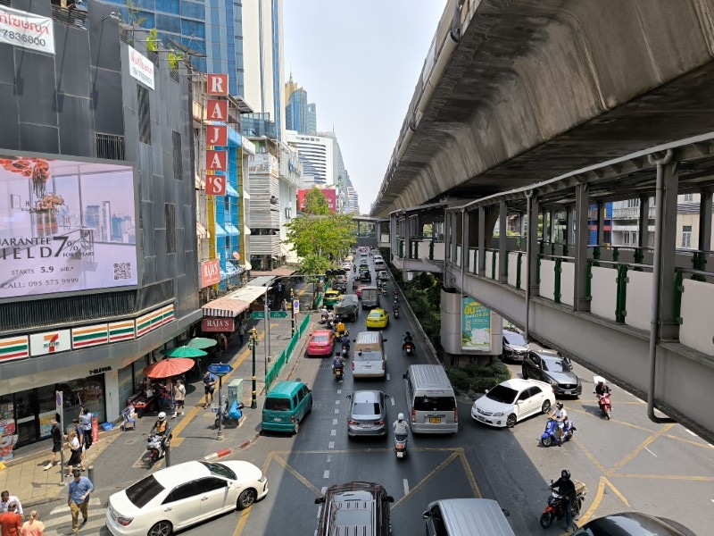 Busy Sukhumvit Road with BTS Skytrain overhead in Bangkok