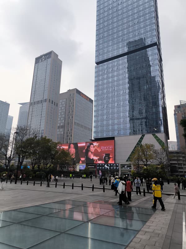 Glass high-rise towers over a downtown plaza in Chengdu