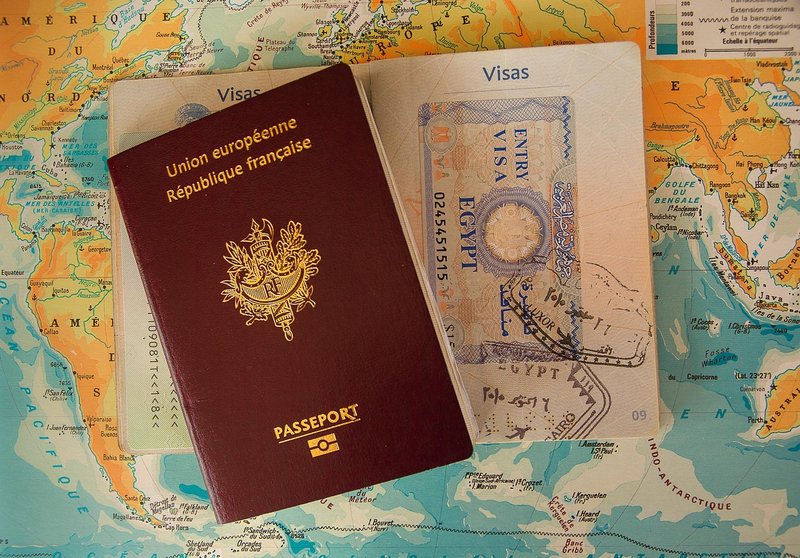 Passport with visa stamps and a world map