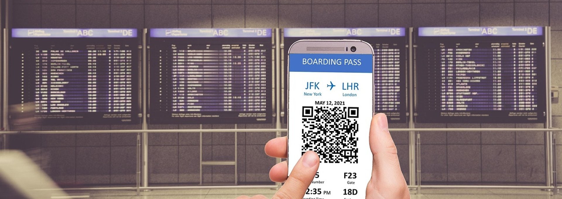 Traveler checking a QR code boarding pass at an airport gate