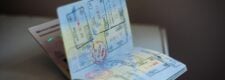 Open passport with entry and exit stamps