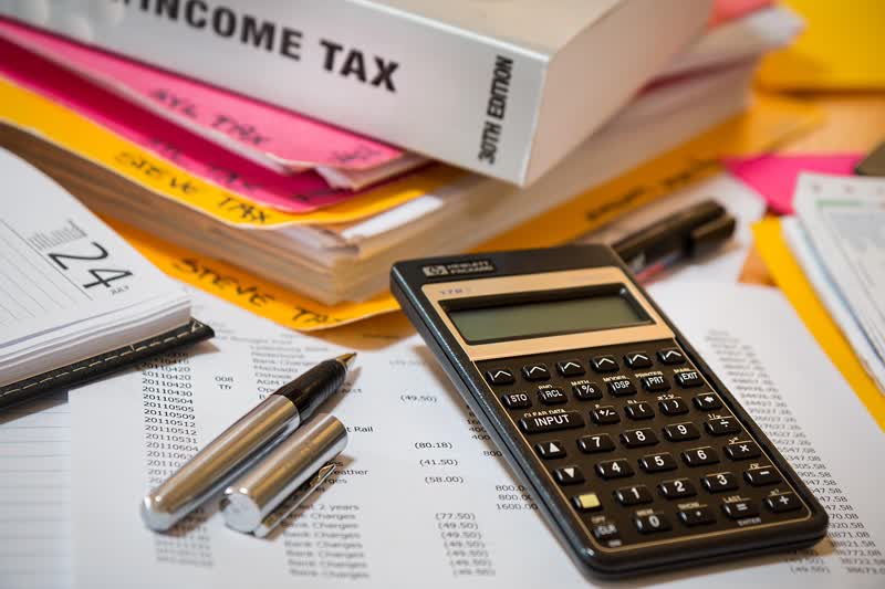 Calculating tax with a calculator and paperwork